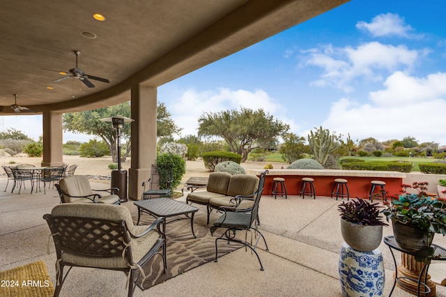 view of patio featuring ceiling fan, exterior bar, and an outdoor living space