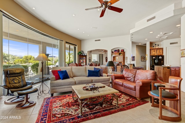 living room featuring light tile patterned floors and ceiling fan