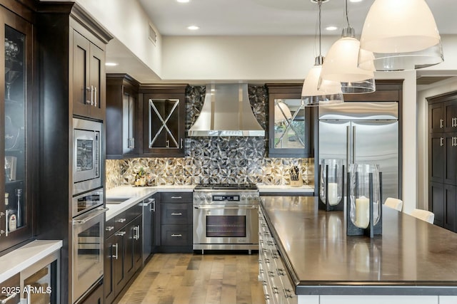 6929 E Montreal Pl, Scottsdale, AZ 85254 - kitchen featuring decorative backsplash, built in appliances, wall chimney exhaust hood, and a kitchen island