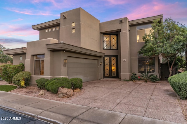 6929 E Montreal Pl, Scottsdale, AZ 85254 - pueblo-style house featuring concrete driveway, an attached garage, and stucco siding