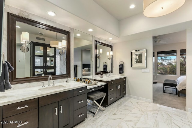 6929 E Montreal Pl, Scottsdale, AZ 85254 - ensuite bathroom featuring ensuite bathroom, baseboards, recessed lighting, vanity, and marble finish floor
