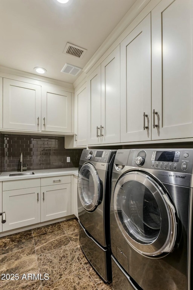 6929 E Montreal Pl, Scottsdale, AZ 85254 - laundry room featuring a sink, stone finish floor, visible vents, cabinet space, and washing machine and clothes dryer