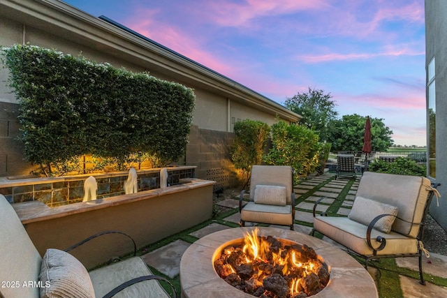 6929 E Montreal Pl, Scottsdale, AZ 85254 - patio terrace at dusk with an outdoor fire pit and fence