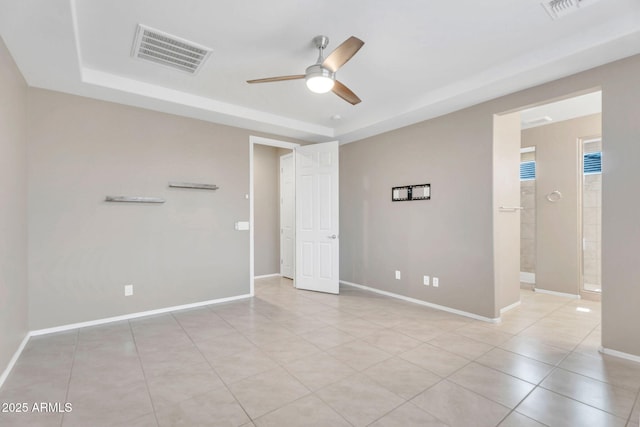 10160 E Harvest Rd, Florence, AZ 85132 - unfurnished bedroom with a raised ceiling, light tile patterned floors, baseboards, and ensuite bathroom