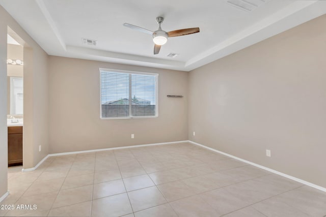 10160 E Harvest Rd, Florence, AZ 85132 - spare room featuring a raised ceiling, ceiling fan, baseboards, and light tile patterned floors