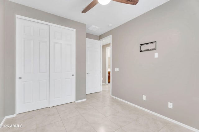 10160 E Harvest Rd, Florence, AZ 85132 - unfurnished bedroom with a closet, baseboards, light tile patterned floors, and ceiling fan