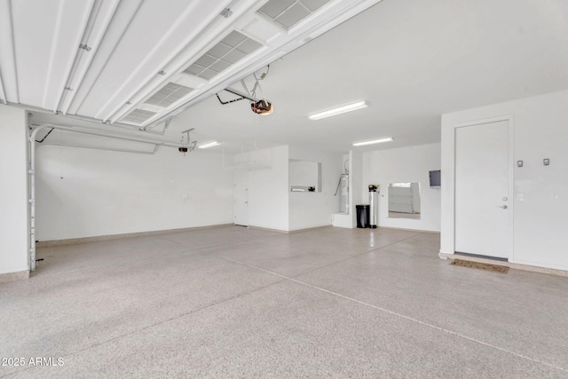 10160 E Harvest Rd, Florence, AZ 85132 - garage featuring a garage door opener and baseboards