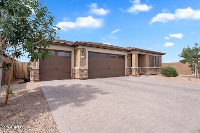 10160 E Harvest Rd, Florence, AZ 85132 - prairie-style home with stone siding, an attached garage, decorative driveway, and stucco siding