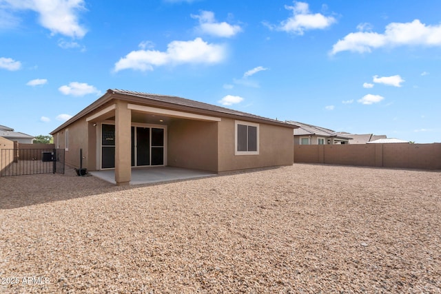 10160 E Harvest Rd, Florence, AZ 85132 - rear view of property with a patio area, stucco siding, a fenced backyard, and a gate