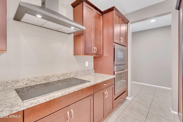 10160 E Harvest Rd, Florence, AZ 85132 - kitchen featuring oven, wall chimney range hood, black electric cooktop, light tile patterned floors, and baseboards