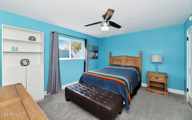 carpeted bedroom with ceiling fan and baseboards