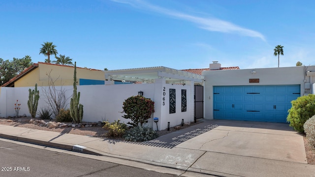 view of front of property with a chimney, stucco siding, concrete driveway, an attached garage, and fence