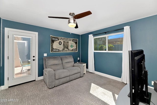 living room featuring ceiling fan, carpet, and baseboards