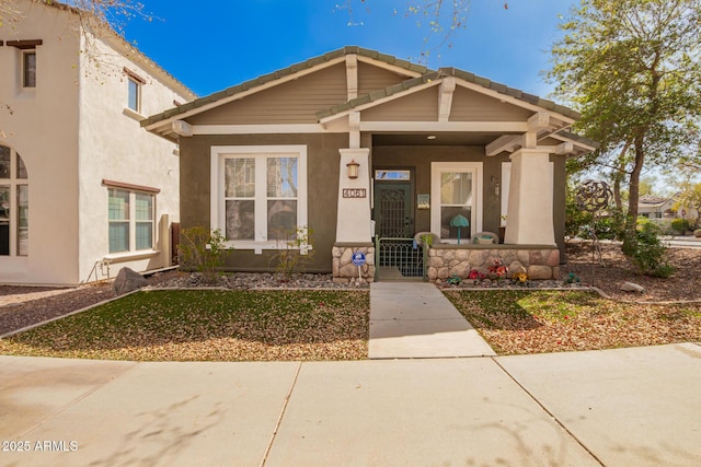 view of front of house with covered porch and stucco siding