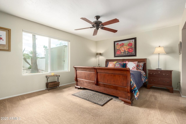 carpeted bedroom with baseboards and a ceiling fan