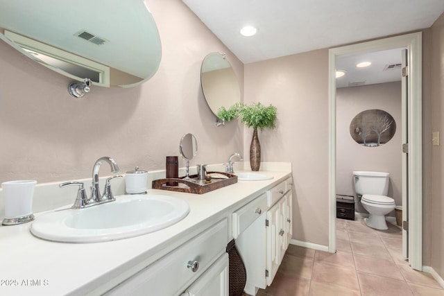 bathroom with tile patterned flooring, visible vents, and a sink