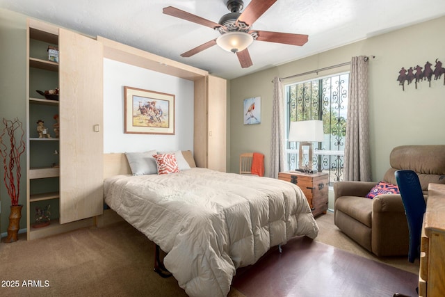 bedroom featuring ceiling fan and carpet