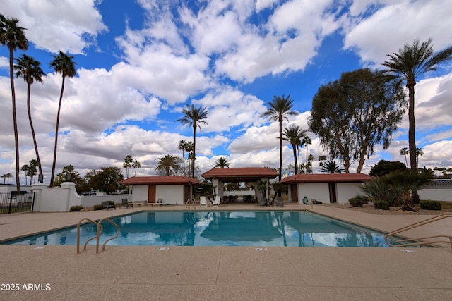 pool featuring a gazebo, a patio area, and fence