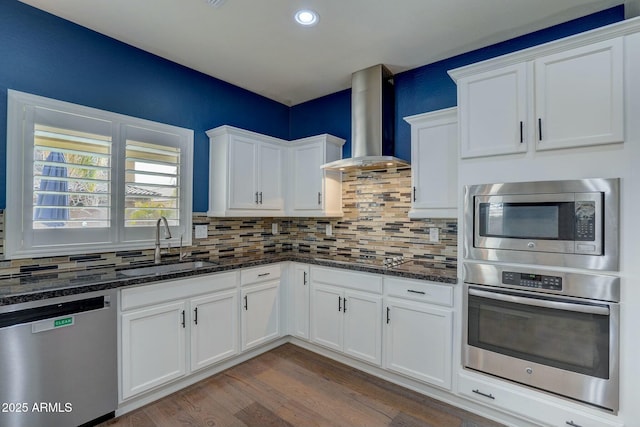10249 E Kinetic Dr, Mesa, AZ 85212 - kitchen featuring appliances with stainless steel finishes, wall chimney exhaust hood, a sink, white cabinetry, and dark wood-style floors
