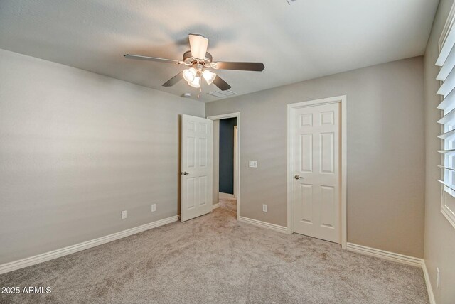 10249 E Kinetic Dr, Mesa, AZ 85212 - unfurnished bedroom with carpet, baseboards, and a ceiling fan