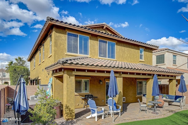 10249 E Kinetic Dr, Mesa, AZ 85212 - back of house with a tile roof, fence, a patio, stucco siding, and central AC