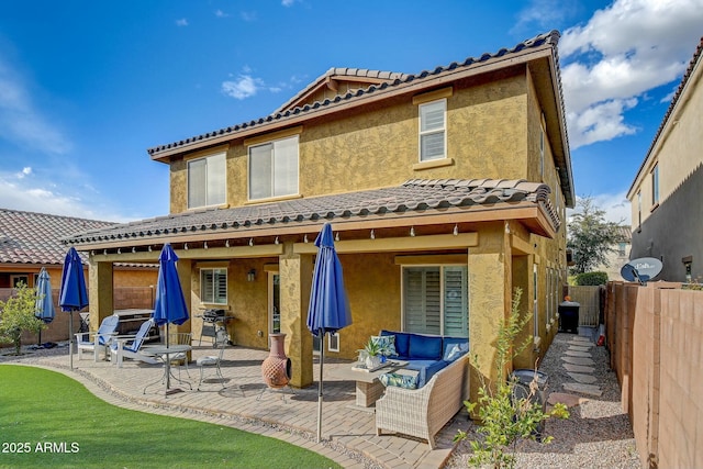 10249 E Kinetic Dr, Mesa, AZ 85212 - back of property with a patio area, a tiled roof, a fenced backyard, stucco siding, and an outdoor living space
