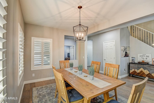 10249 E Kinetic Dr, Mesa, AZ 85212 - dining room with a chandelier, wood finished floors, baseboards, and stairs