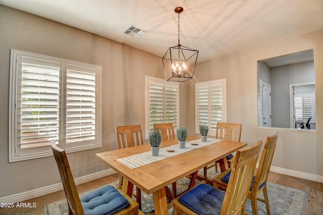 10249 E Kinetic Dr, Mesa, AZ 85212 - dining area featuring a chandelier, baseboards, and wood finished floors