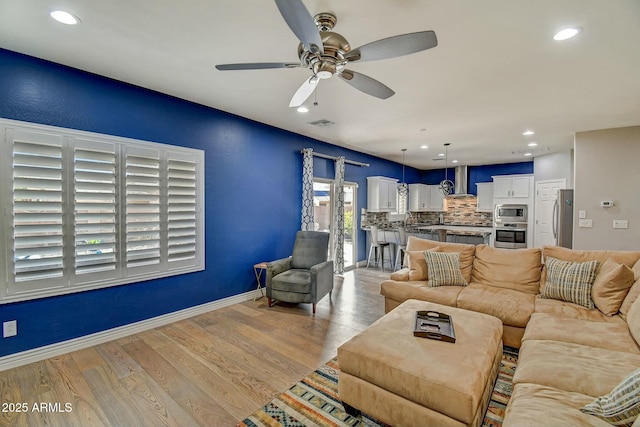 10249 E Kinetic Dr, Mesa, AZ 85212 - living room with ceiling fan, light wood-style flooring, recessed lighting, and baseboards