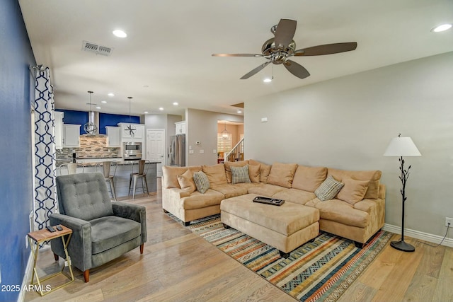 10249 E Kinetic Dr, Mesa, AZ 85212 - living area with stairs, light wood-style flooring, a ceiling fan, recessed lighting, and baseboards