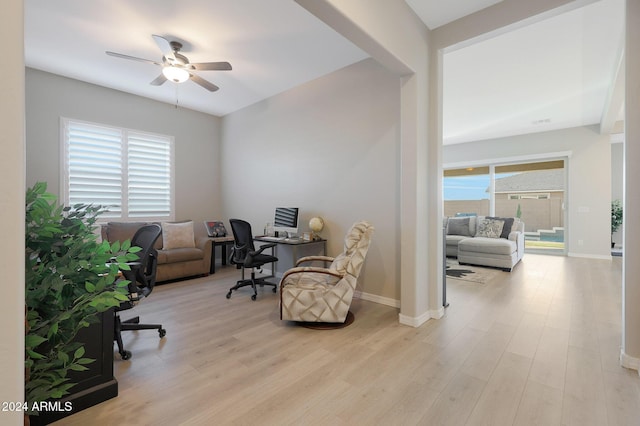 home office with baseboards, ceiling fan, and wood finished floors
