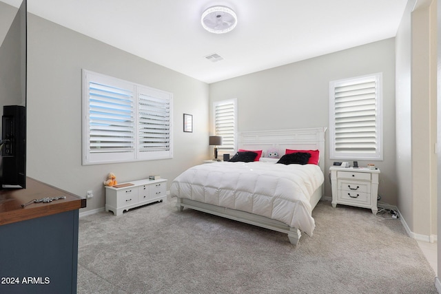 carpeted bedroom with baseboards and visible vents