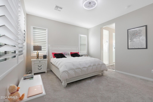 bedroom with light colored carpet, baseboards, and visible vents