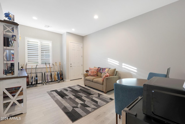 living room with recessed lighting, visible vents, and light wood-type flooring