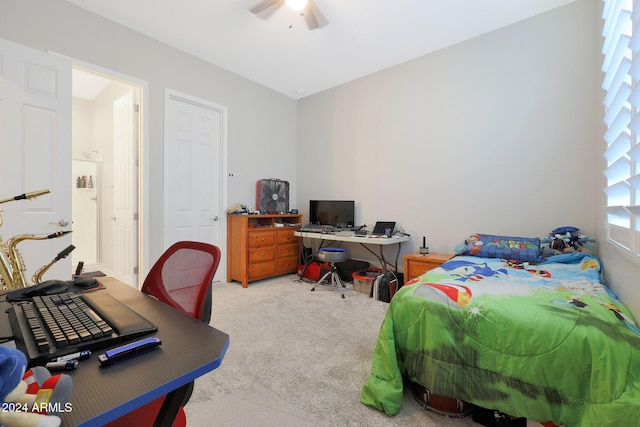 bedroom with ceiling fan and light carpet