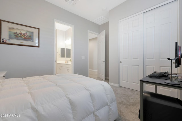 bedroom featuring light colored carpet, baseboards, ensuite bathroom, visible vents, and a closet