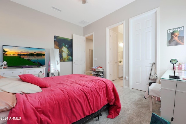 bedroom featuring ensuite bathroom, carpet flooring, and visible vents