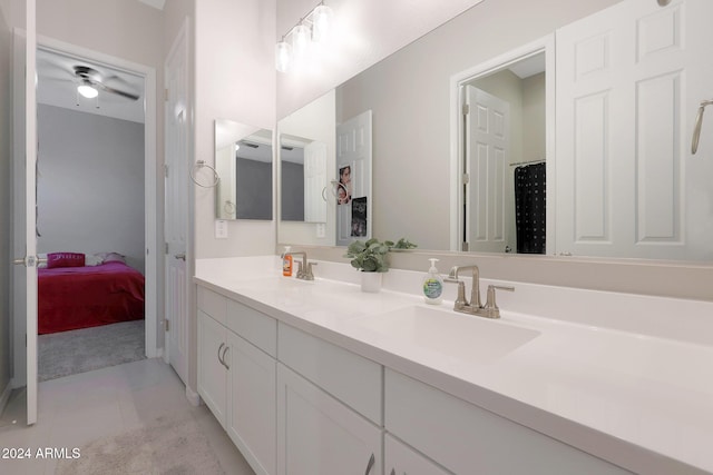 ensuite bathroom featuring a sink, double vanity, and connected bathroom