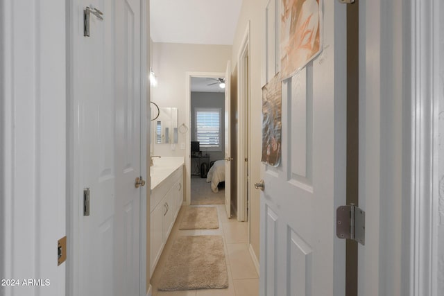 bathroom featuring tile patterned floors, a ceiling fan, vanity, and ensuite bath