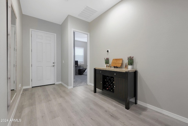 interior space with baseboards and light wood-style flooring