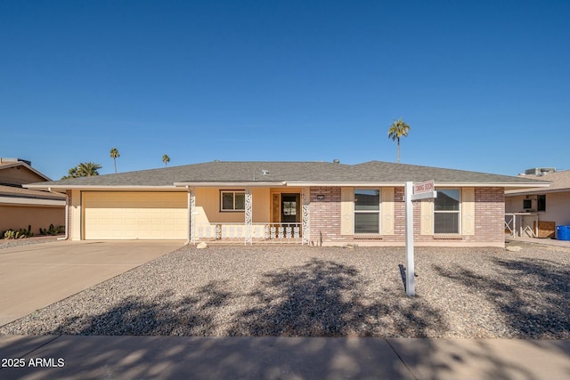 ranch-style house with a porch and a garage