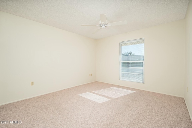 carpeted spare room featuring ceiling fan and a textured ceiling