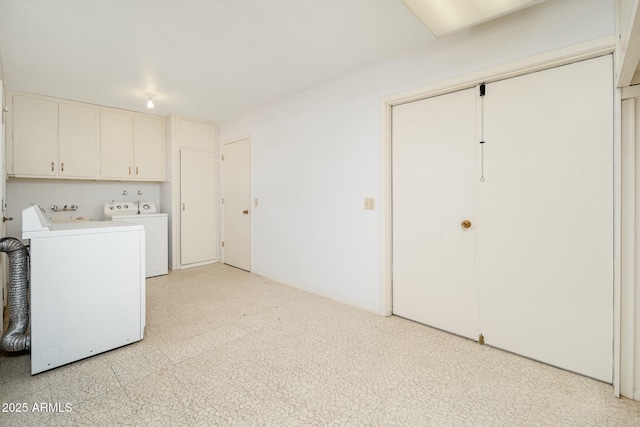 laundry area with separate washer and dryer and cabinets