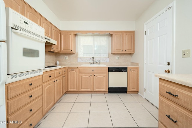 kitchen featuring white appliances, sink, and light brown cabinetry