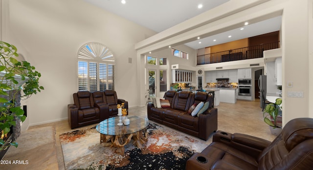 living room featuring a towering ceiling