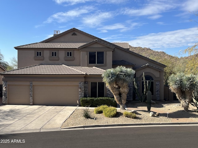 view of front of property featuring a garage and a mountain view