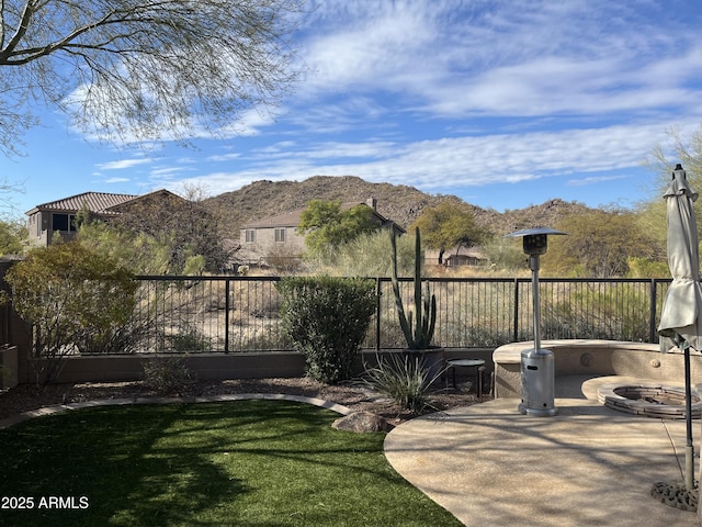 view of yard with a patio, a mountain view, and a fire pit