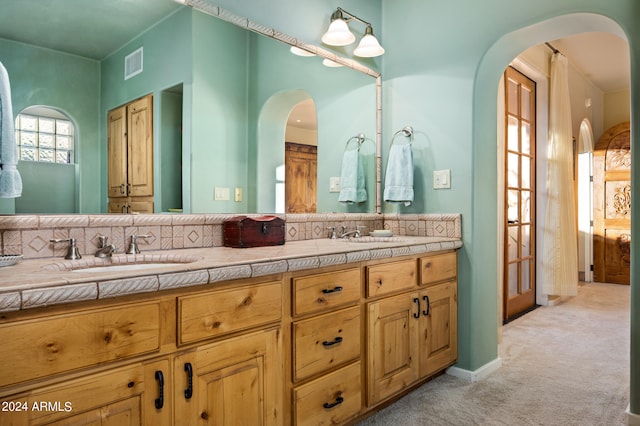 bathroom featuring dual sinks and oversized vanity