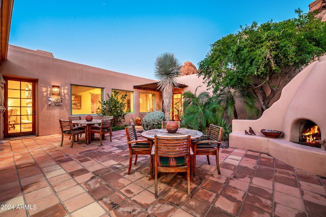 view of terrace featuring an outdoor fireplace