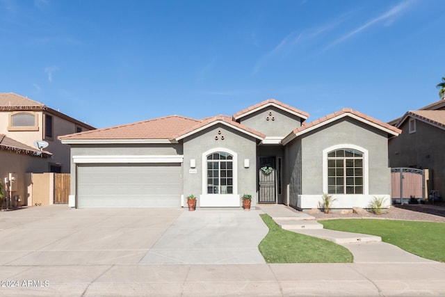 mediterranean / spanish-style home with a garage